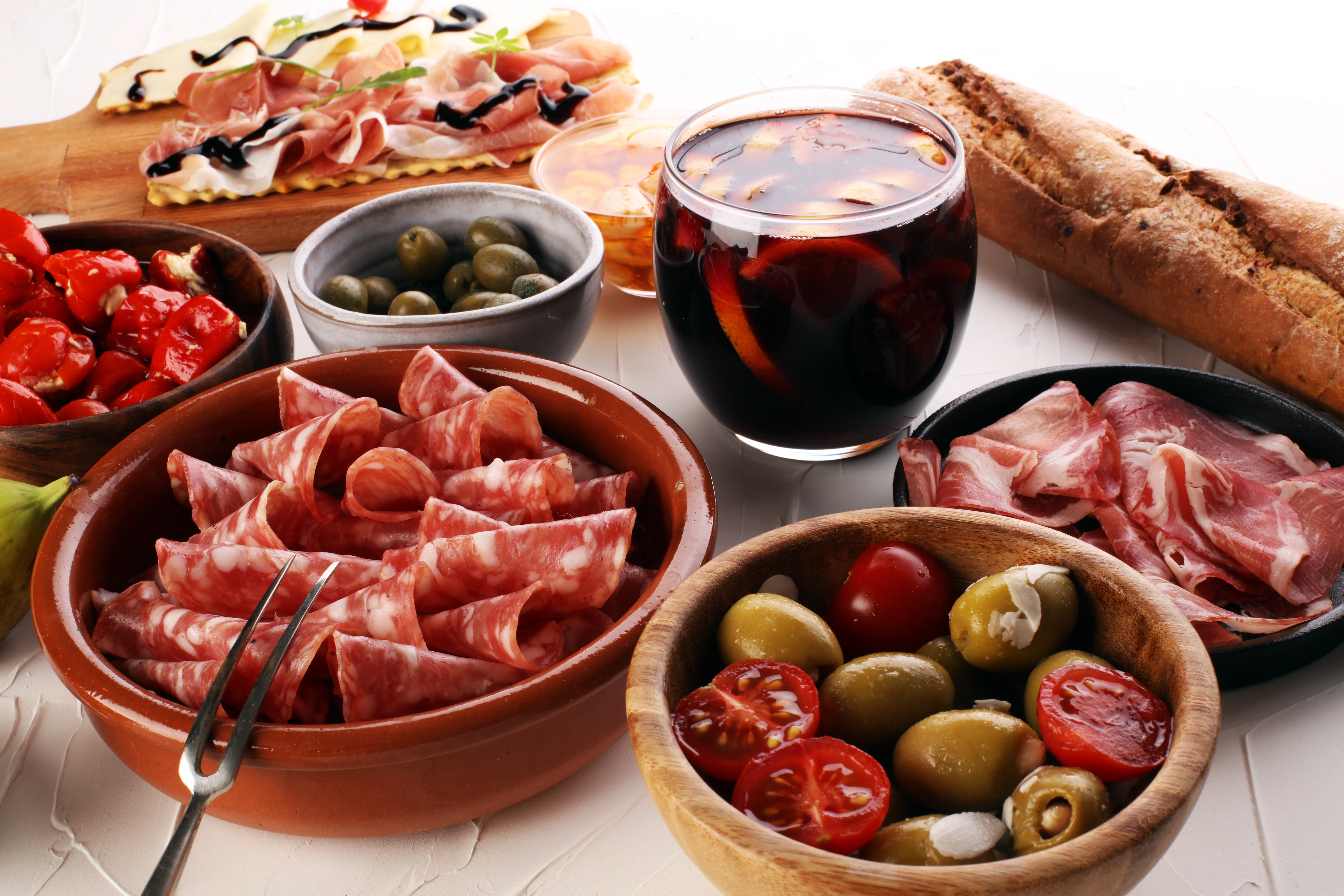 Andalusisk tapas med serranoskinke, oliven og rødvin på rustikt spansk bord