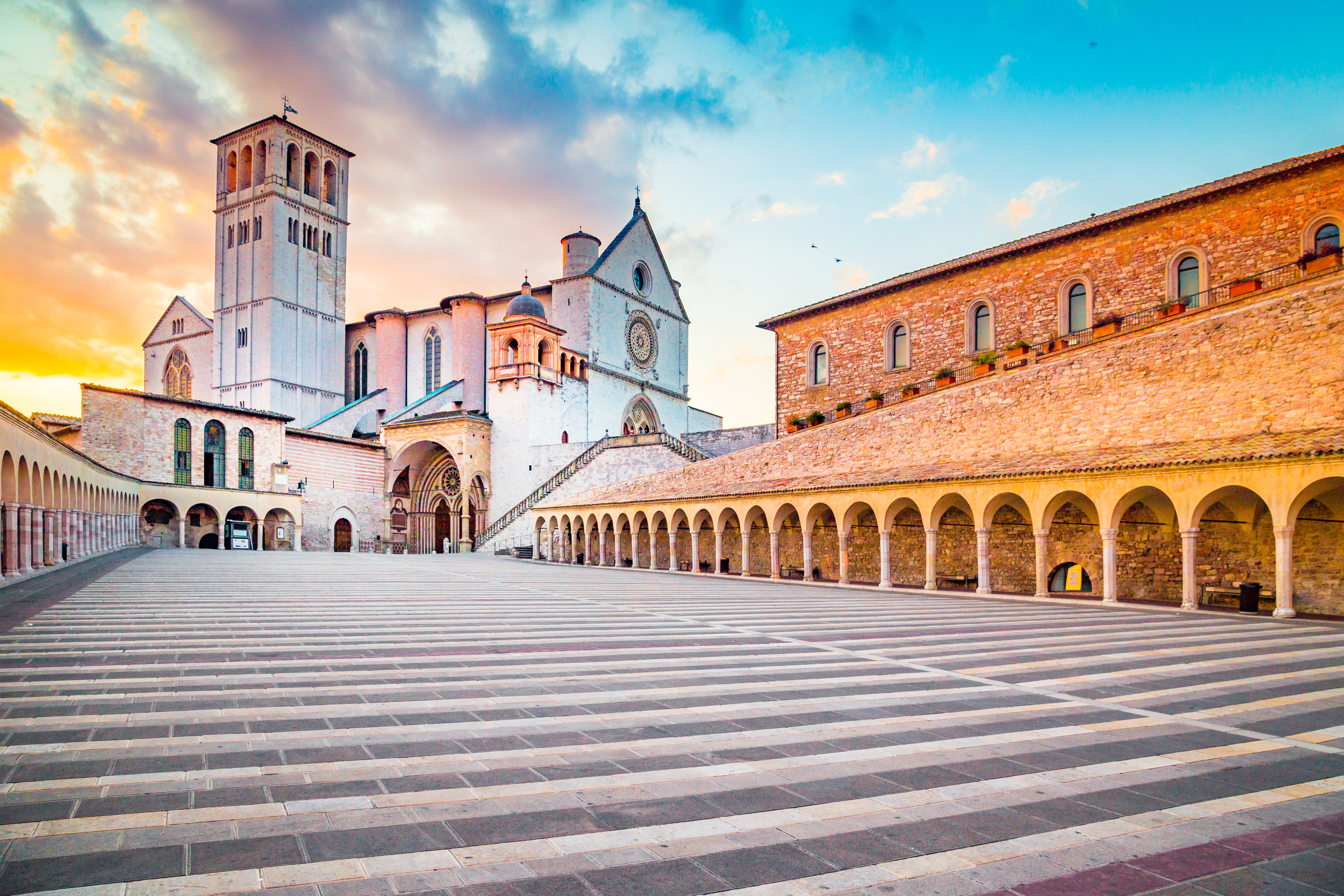 Franciskanerklosteret i Assisi med basilika og middelalderlige buegange i det gyldne lys