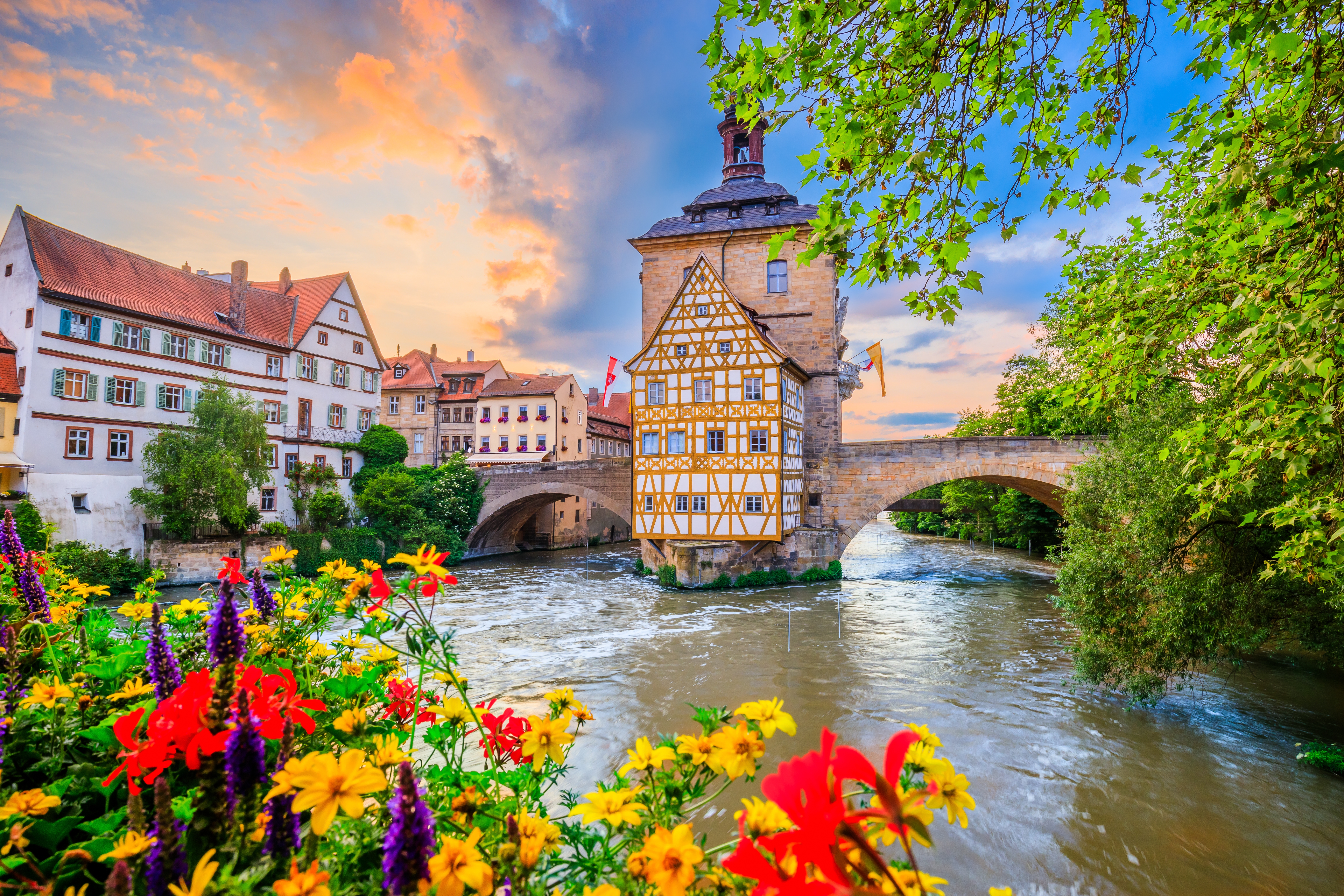 Romantiske Bamberg med farverige blomster og charmerende bindingsværkshuse ved Regnitz floden