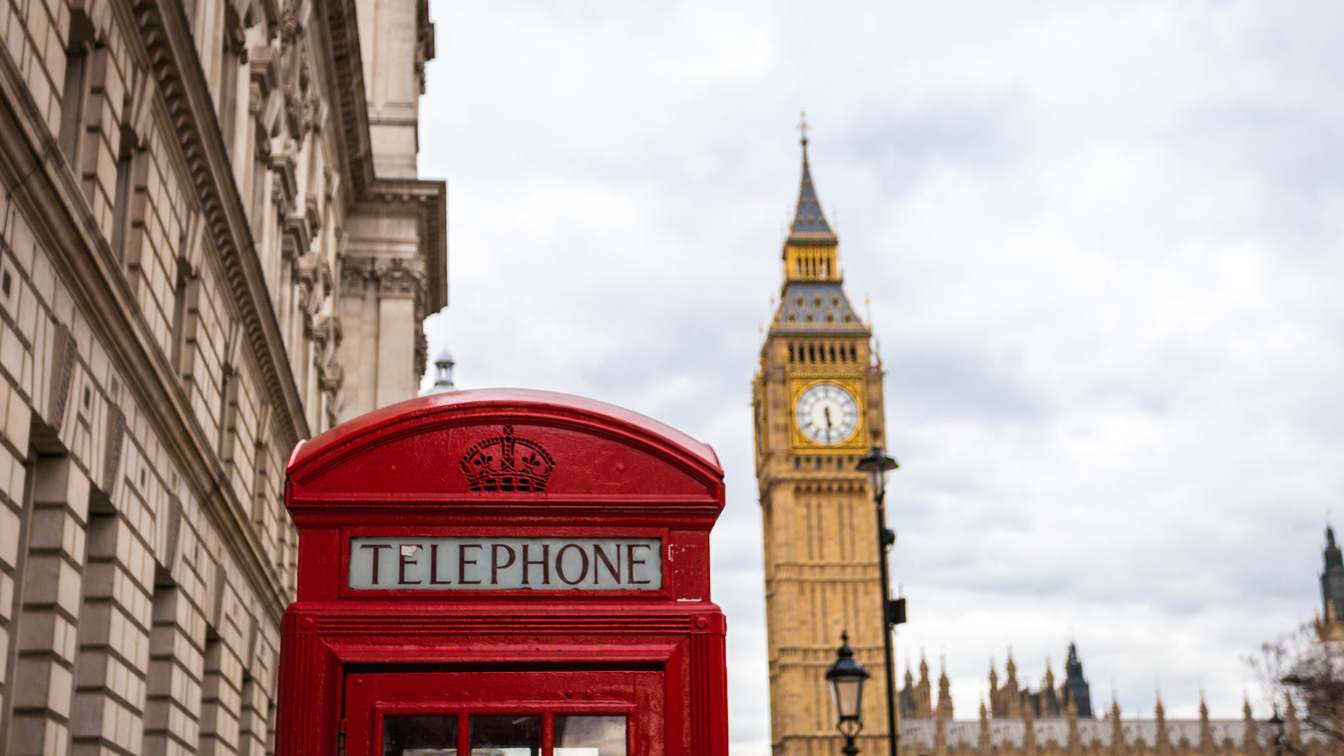 Londons berømte røde telefonboks med udsigt til Big Ben og parlamentet – et ikonisk syn i Storbritanniens hovedstad