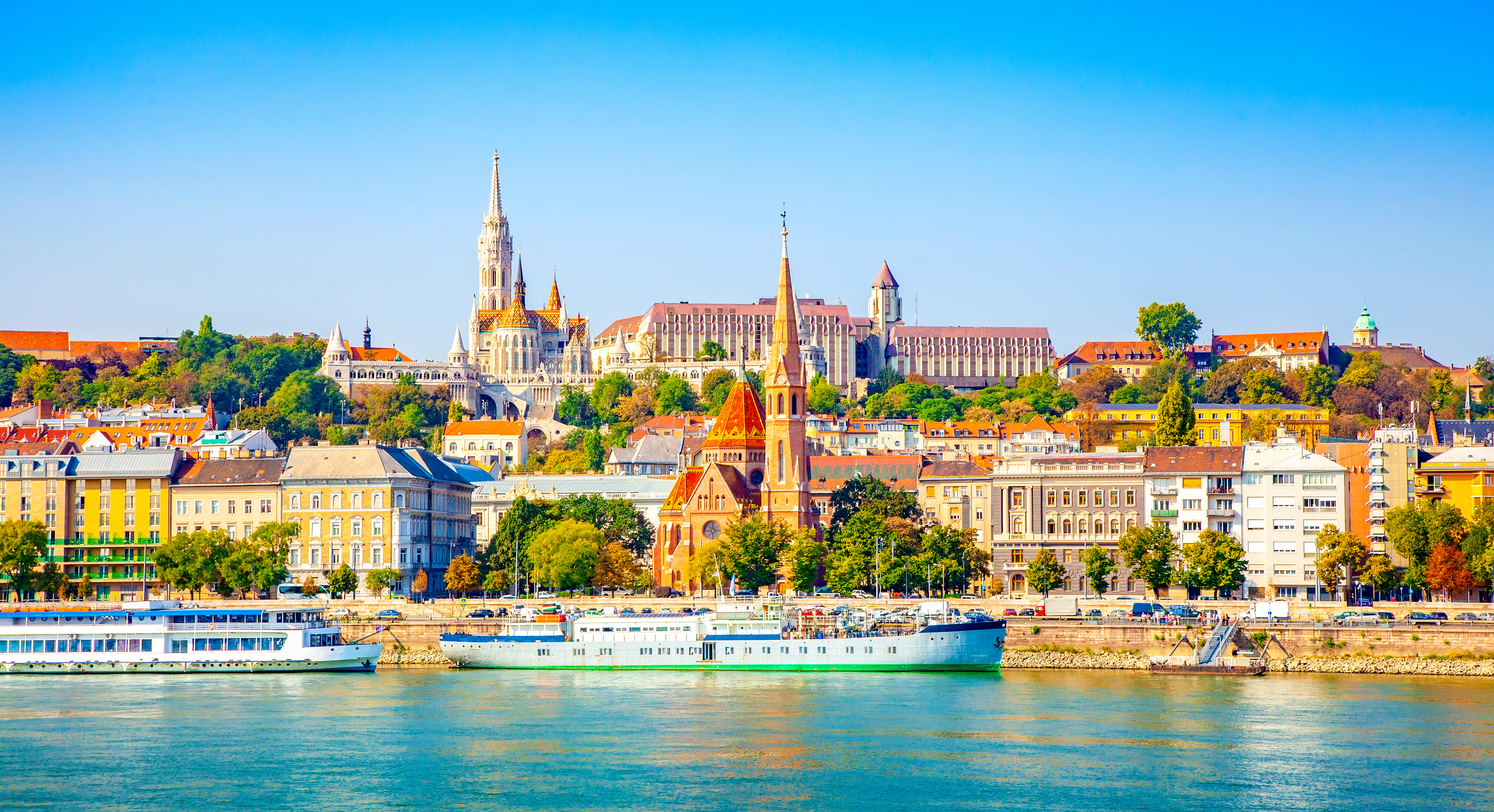 Udsigt over Budapests smukke skyline med den gotiske Matthias Kirke, Fiskerbastionen og farverige bygninger langs Donau-floden