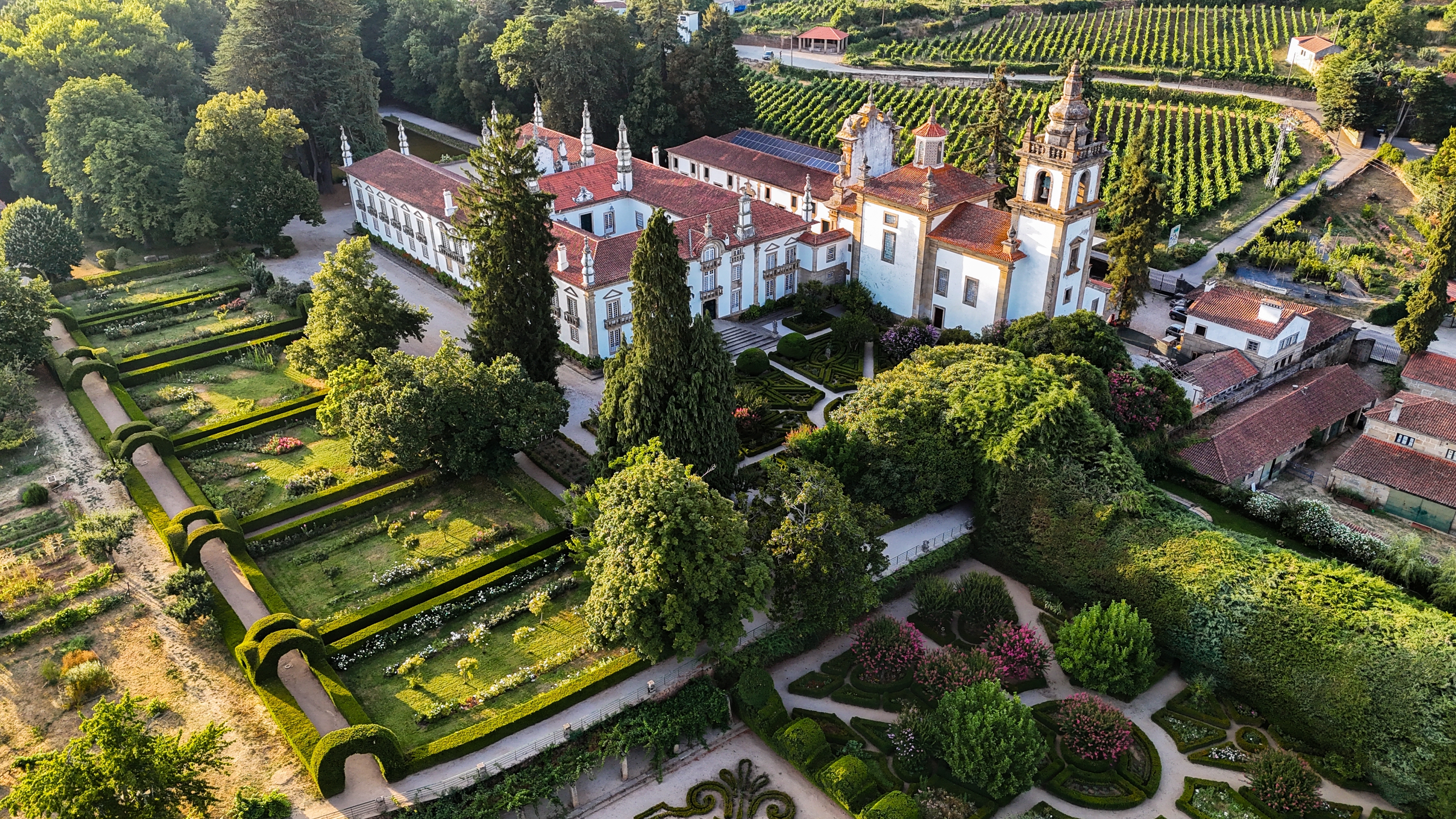 Smuk luftfotovisning af Casa de Mateus i Vila Real, Portugal, med det ikoniske barokpalads, storslåede haver og omkringliggende vinmarker