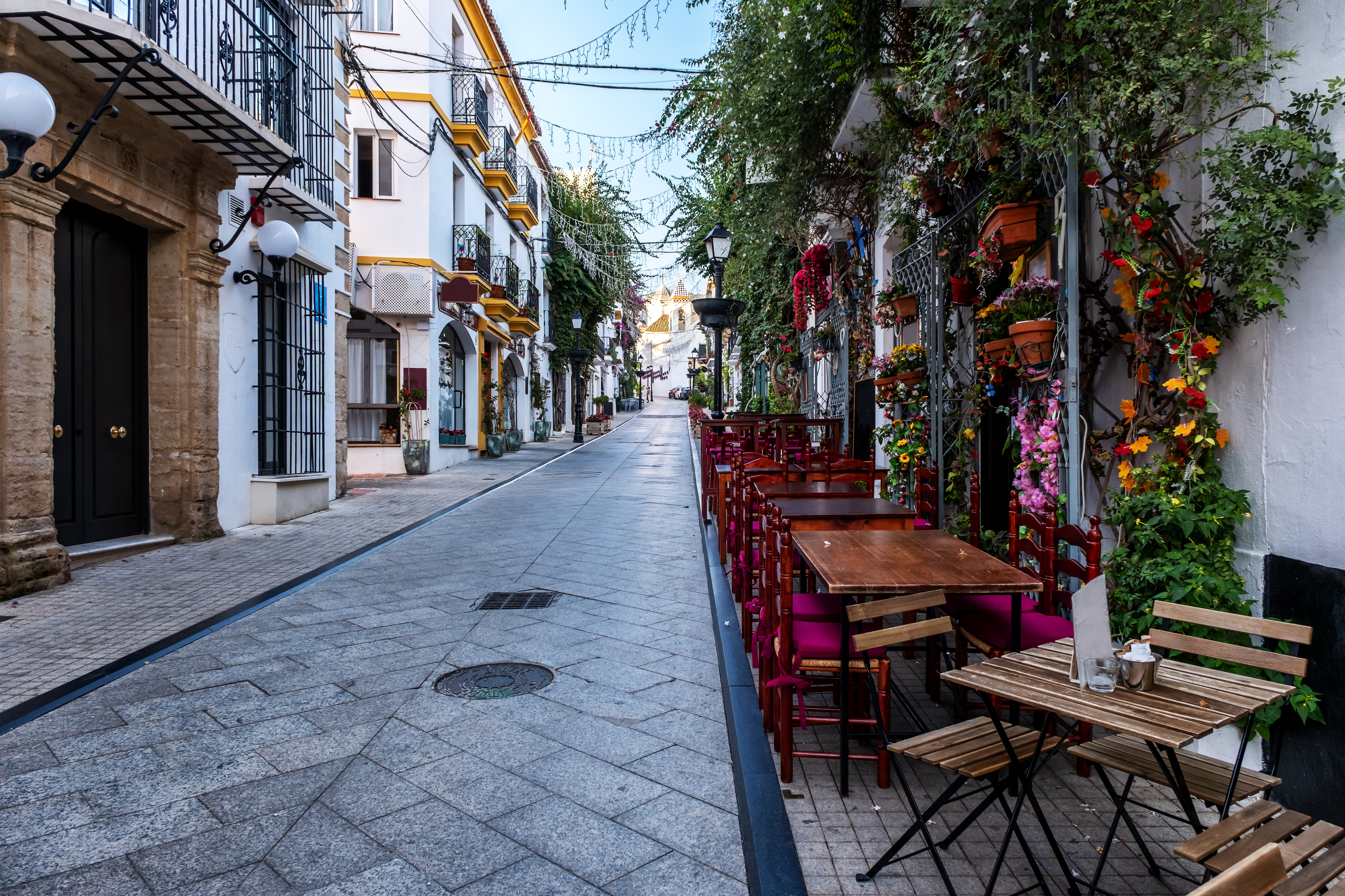 Smuk spansk bygade med udendørs spisning og mediterran arkitektur på Costa del Sol