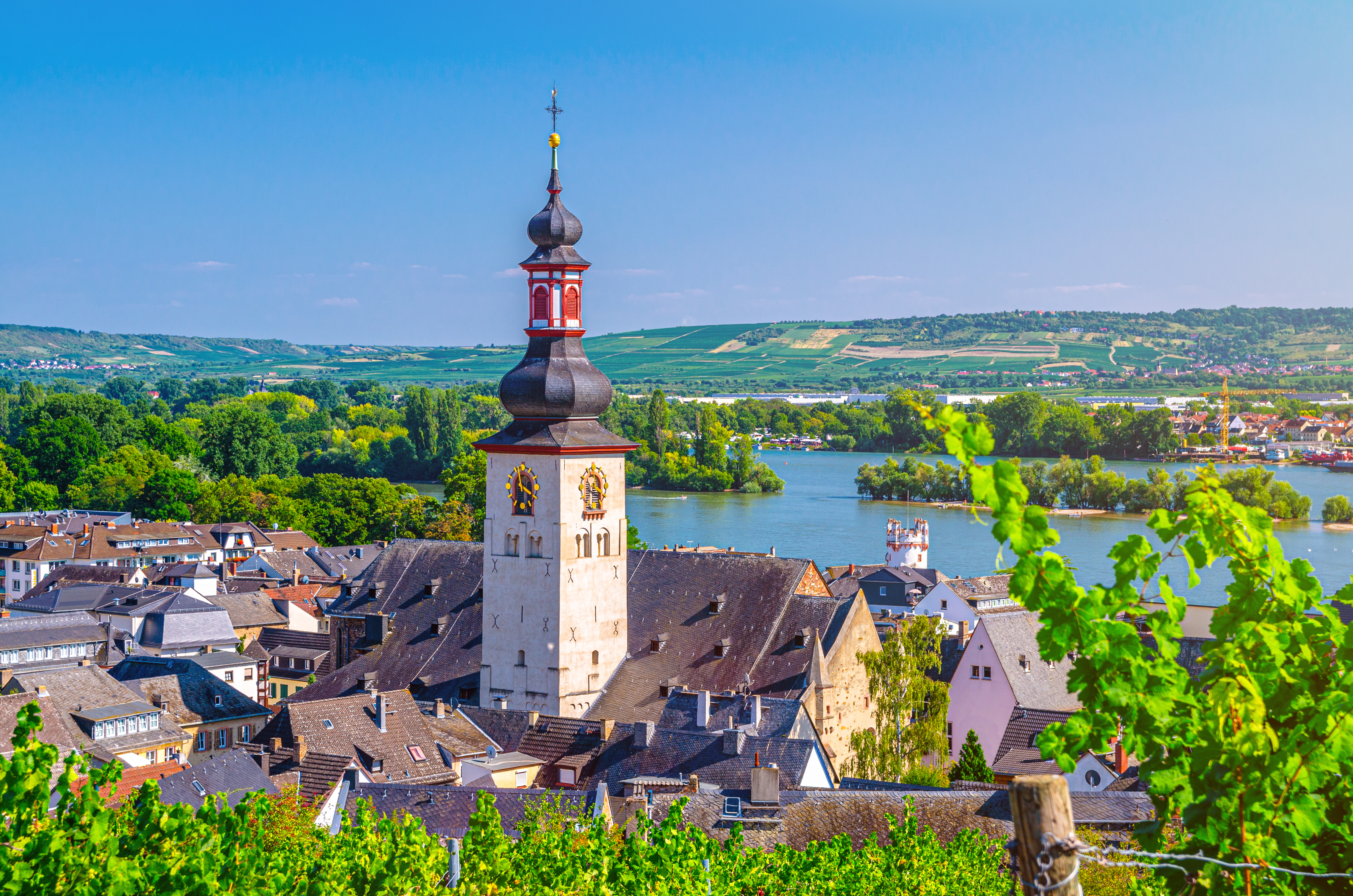 Smuk udsigt over traditionel østrigsk by ved Donau med barok kirke og grønne omgivelser