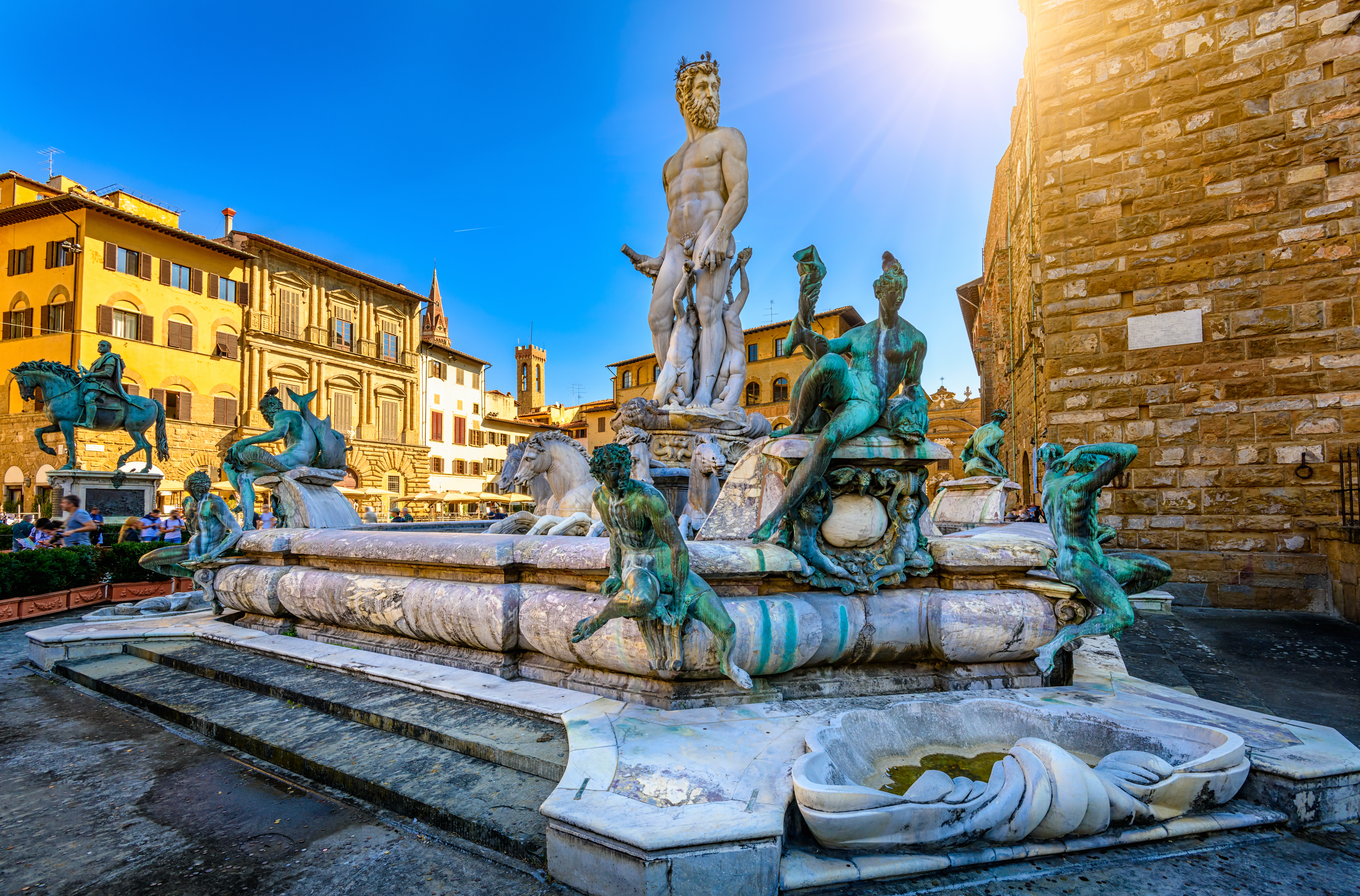 Neptun fontænen i Firenze omgivet af smukke renæssance paladser og blå himmel