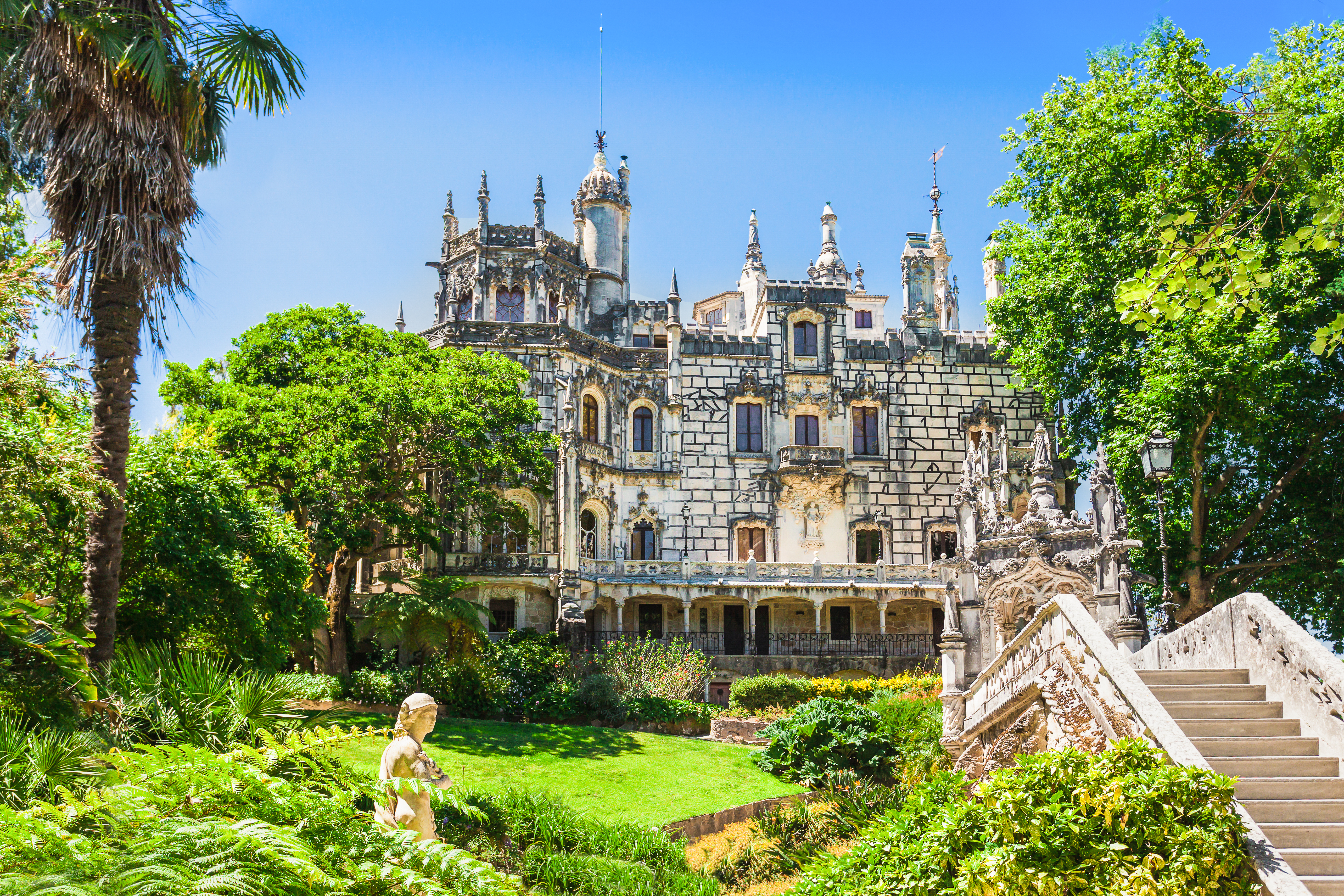 Den historiske Quinta da Regaleira mansion omgivet af frodig vegetation i Sintra