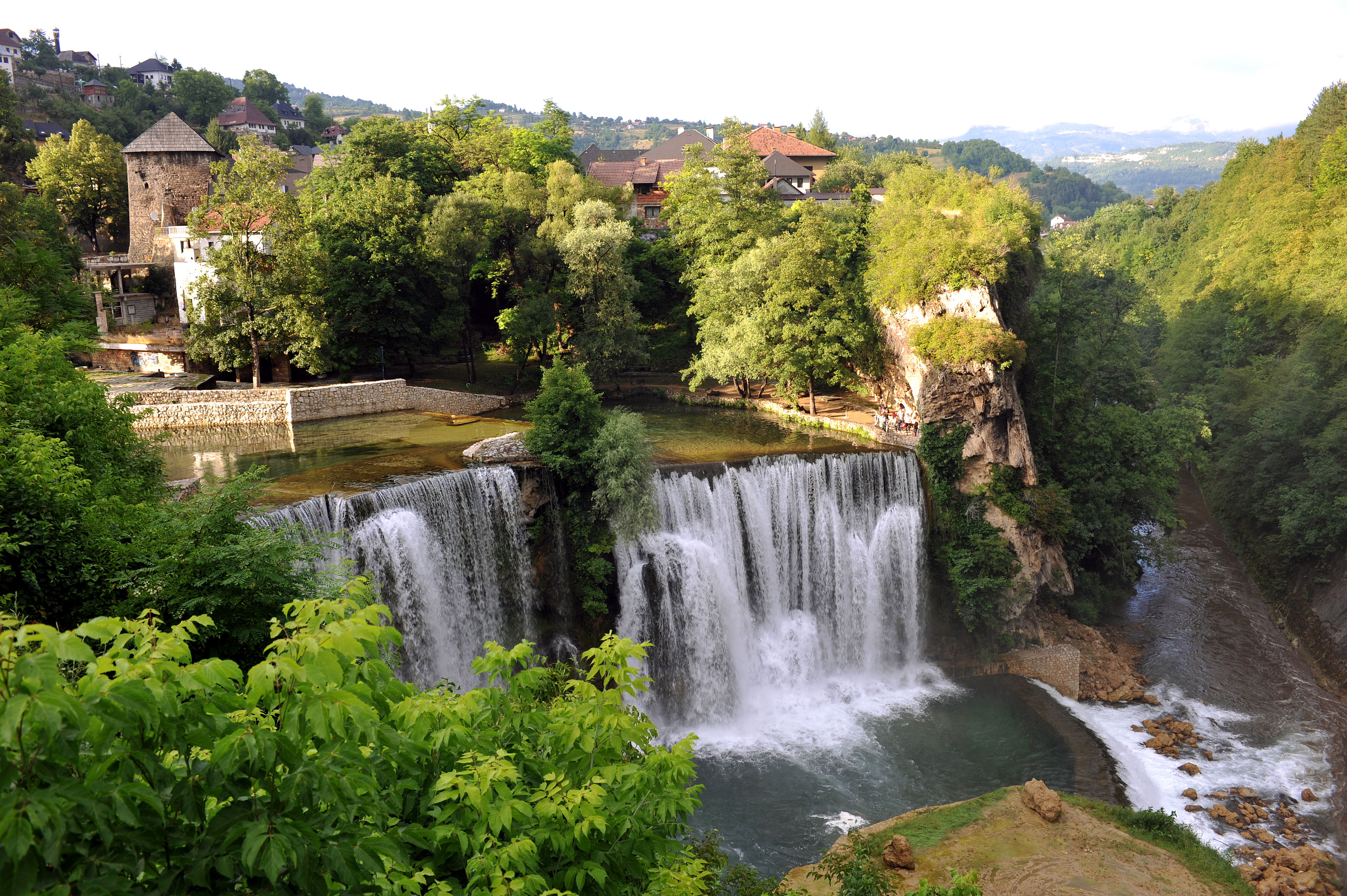Majestætisk vandfald ved Jajce med middelalder fæstning og historiske mure i Bosnien