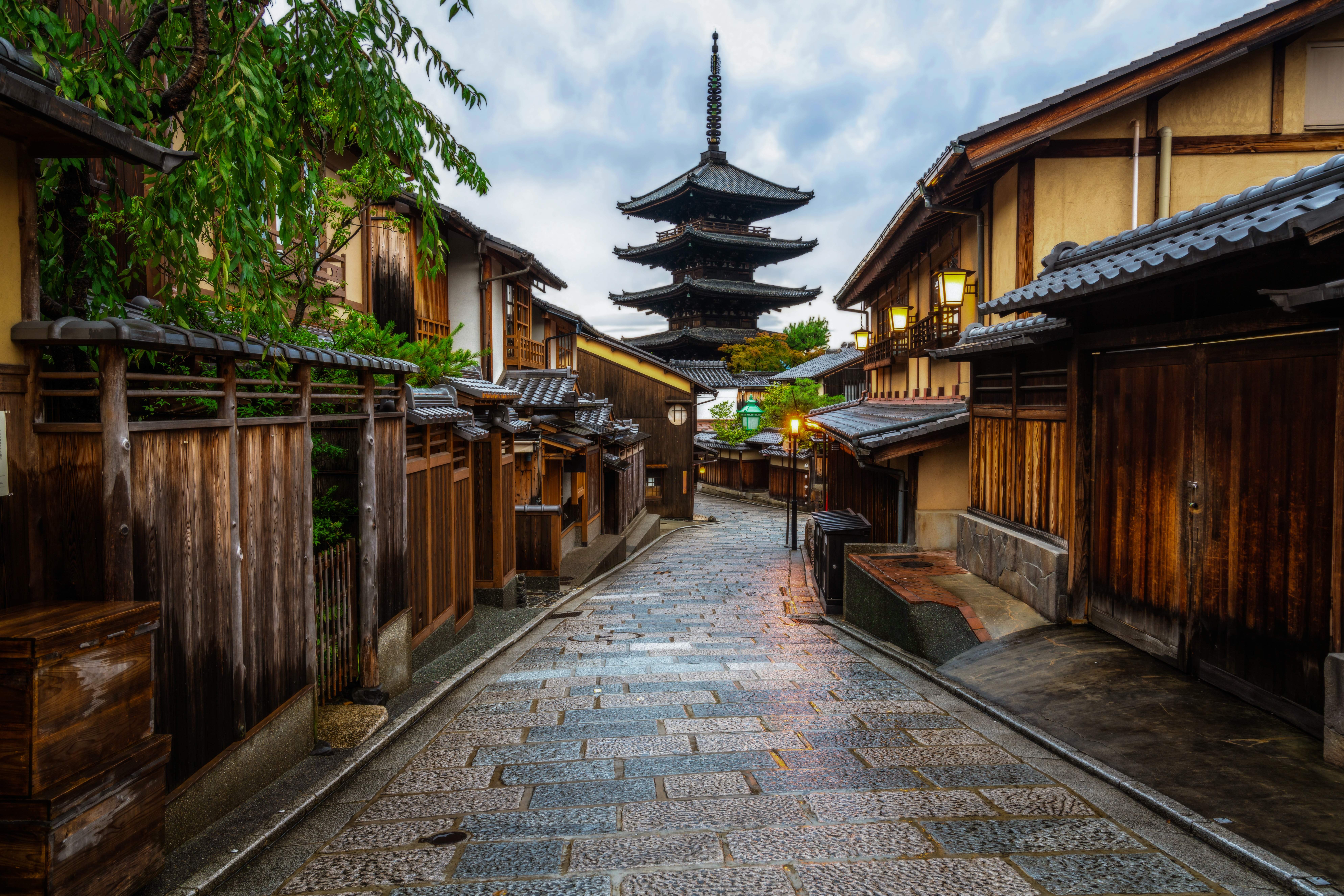 Traditionel japansk gadescene i Kyoto med brolagt Sannenzaka-stræde, gamle træhuse og den berømte Yasaka Pagoda i baggrunden