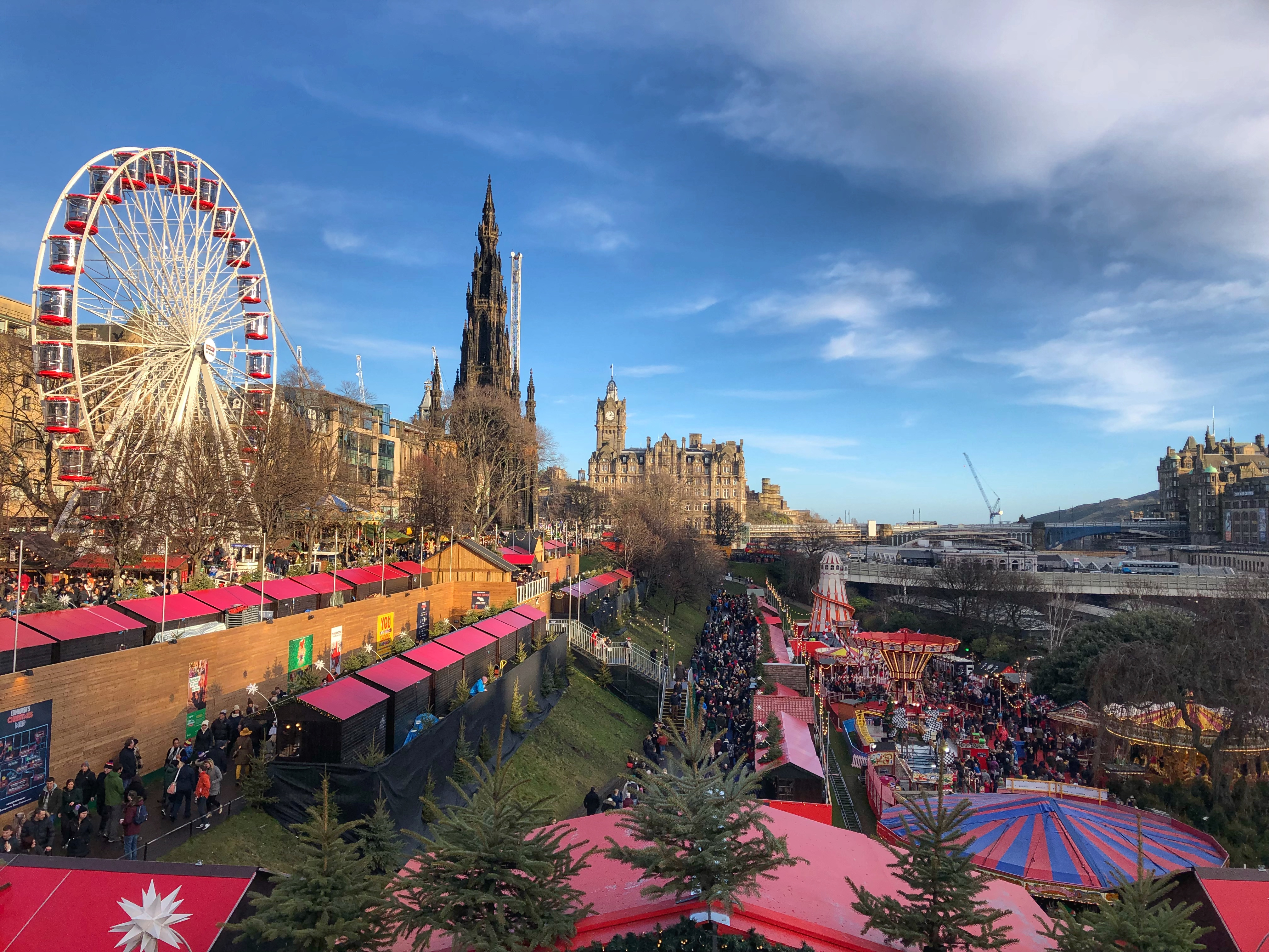 Eventyrligt julemarked i hjertet af Edinburgh med det farverige pariserhjul og festlige boder, der skaber en magisk atmosfære med den historiske by som baggrund
