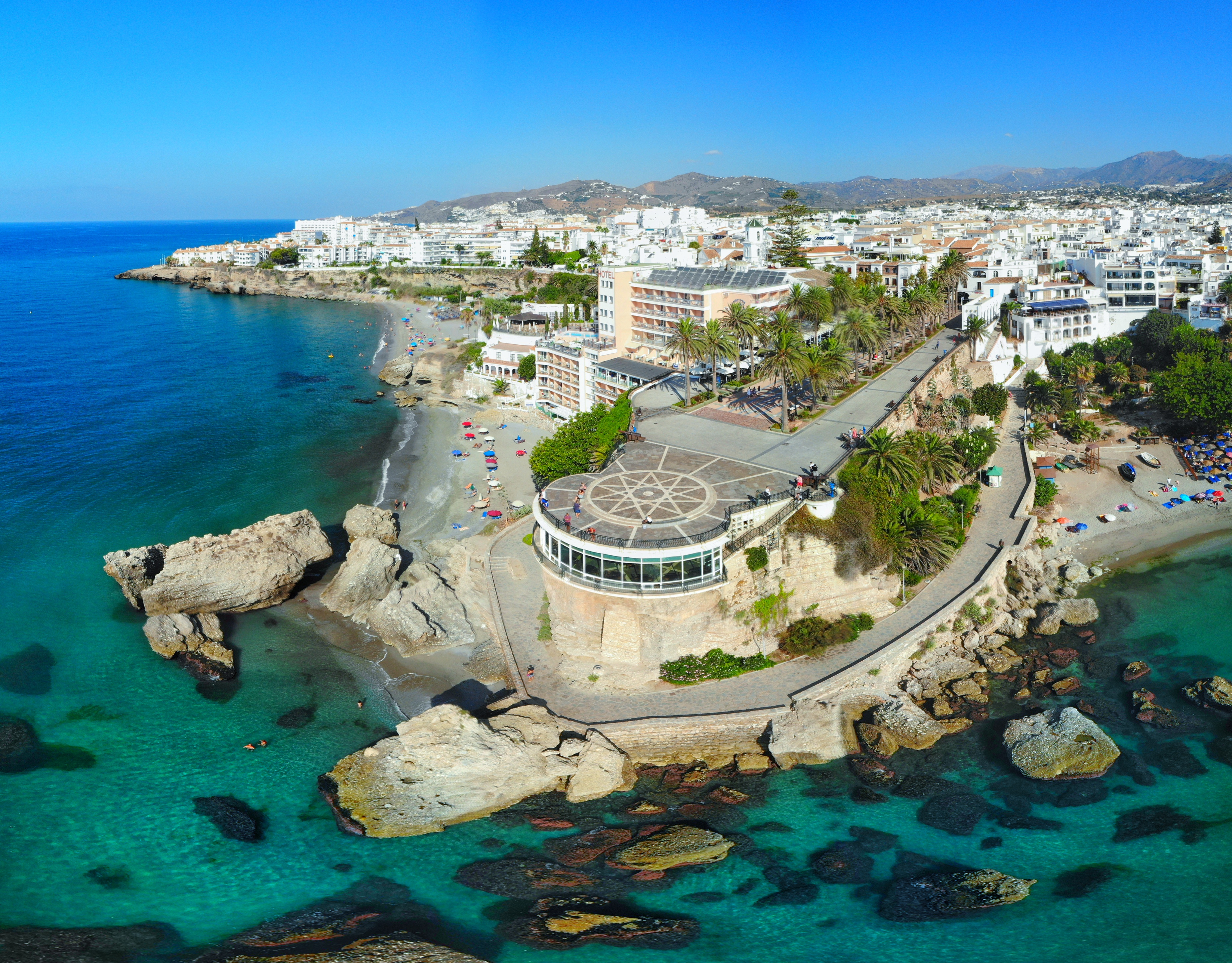 Panoramaudsigt fra luften over Balcon de Europa i Nerja på Costa del Sol med turkisblåt hav og klippekyst