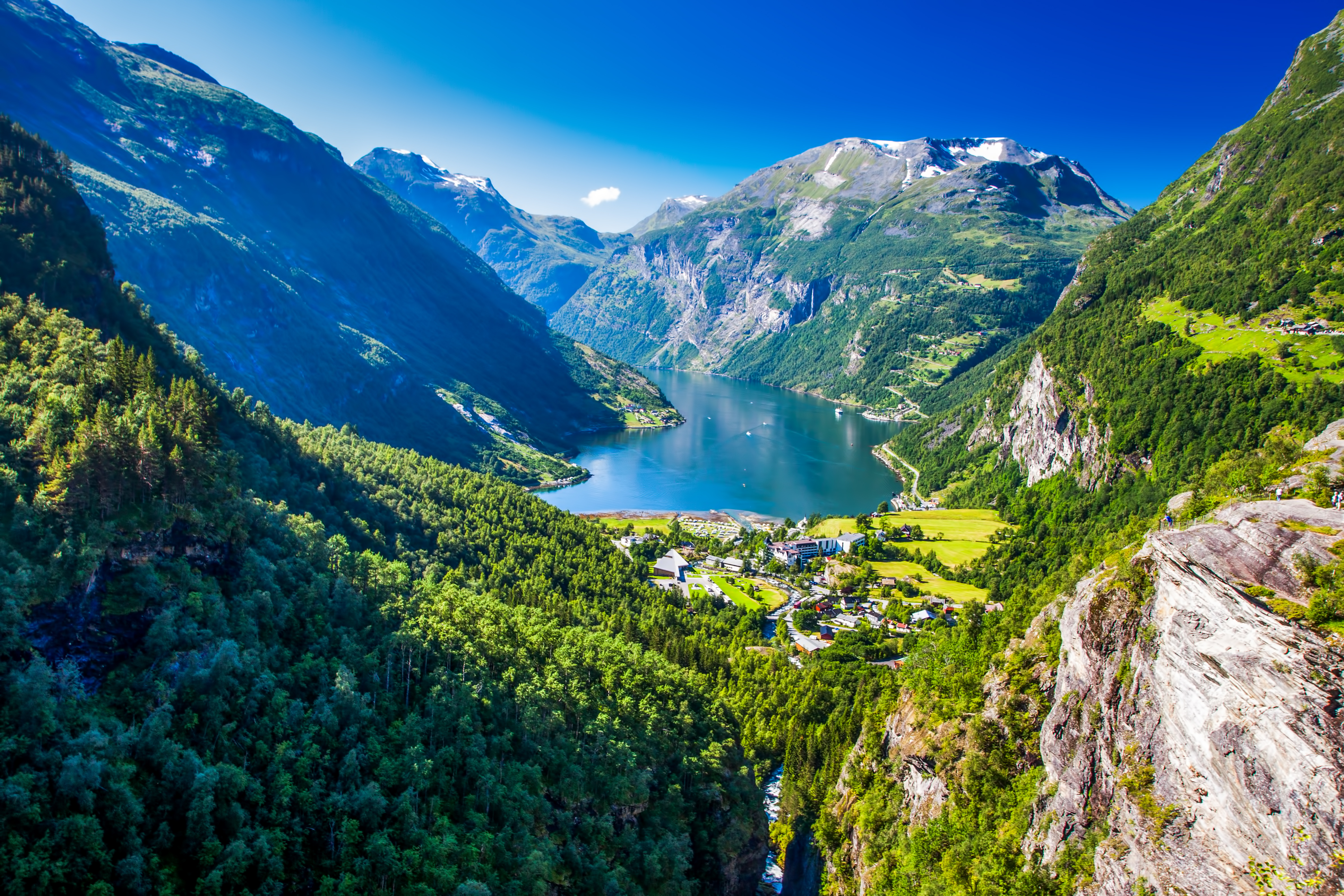 Naturskøn udsigt over Geirangerfjord i Norge om sommeren med grønne bjerge, vandfald og blå fjord