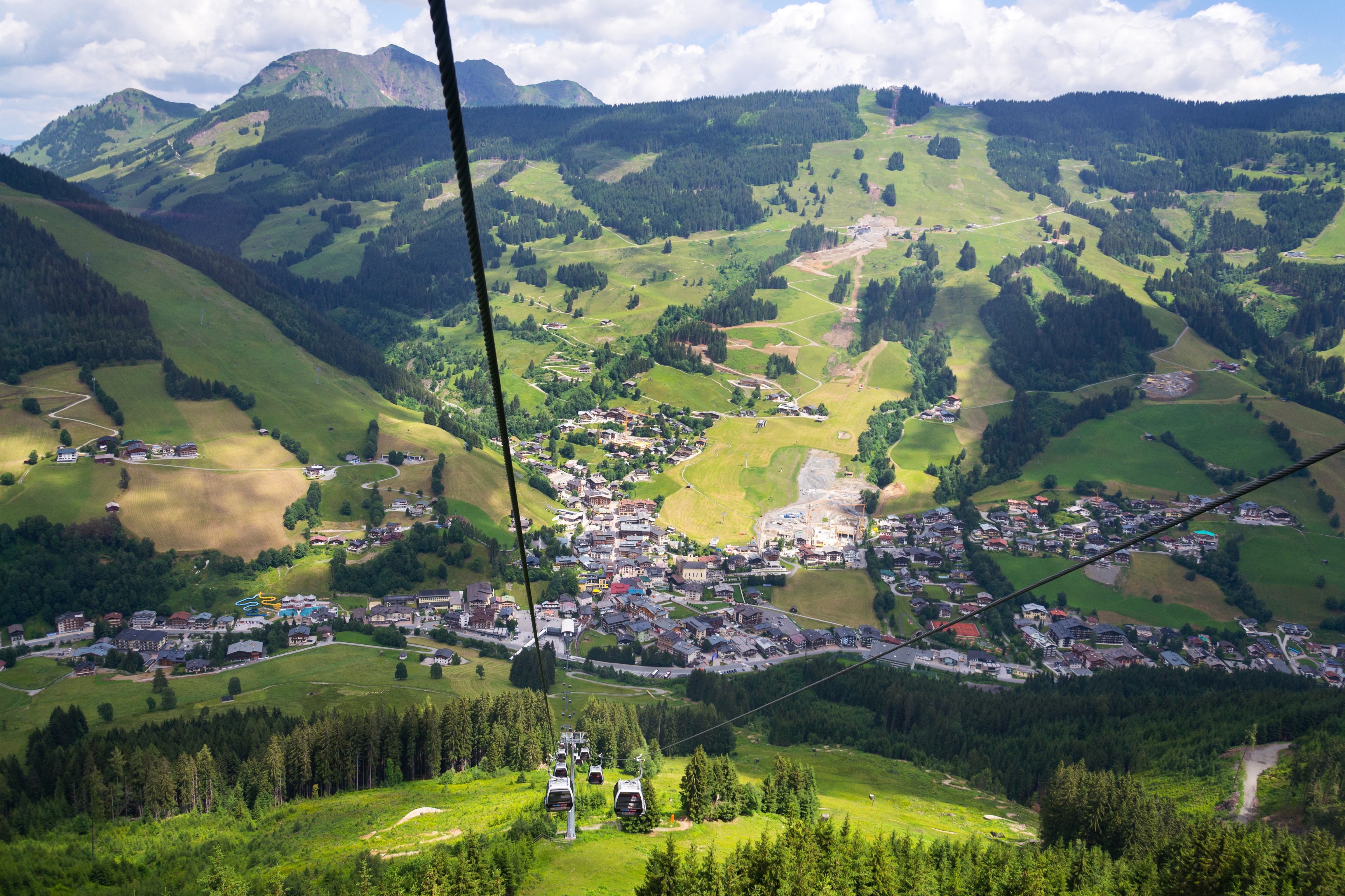 Saalbach-Hinterglemm bjergferie med kabelbane over grøn alpedal i Østrig