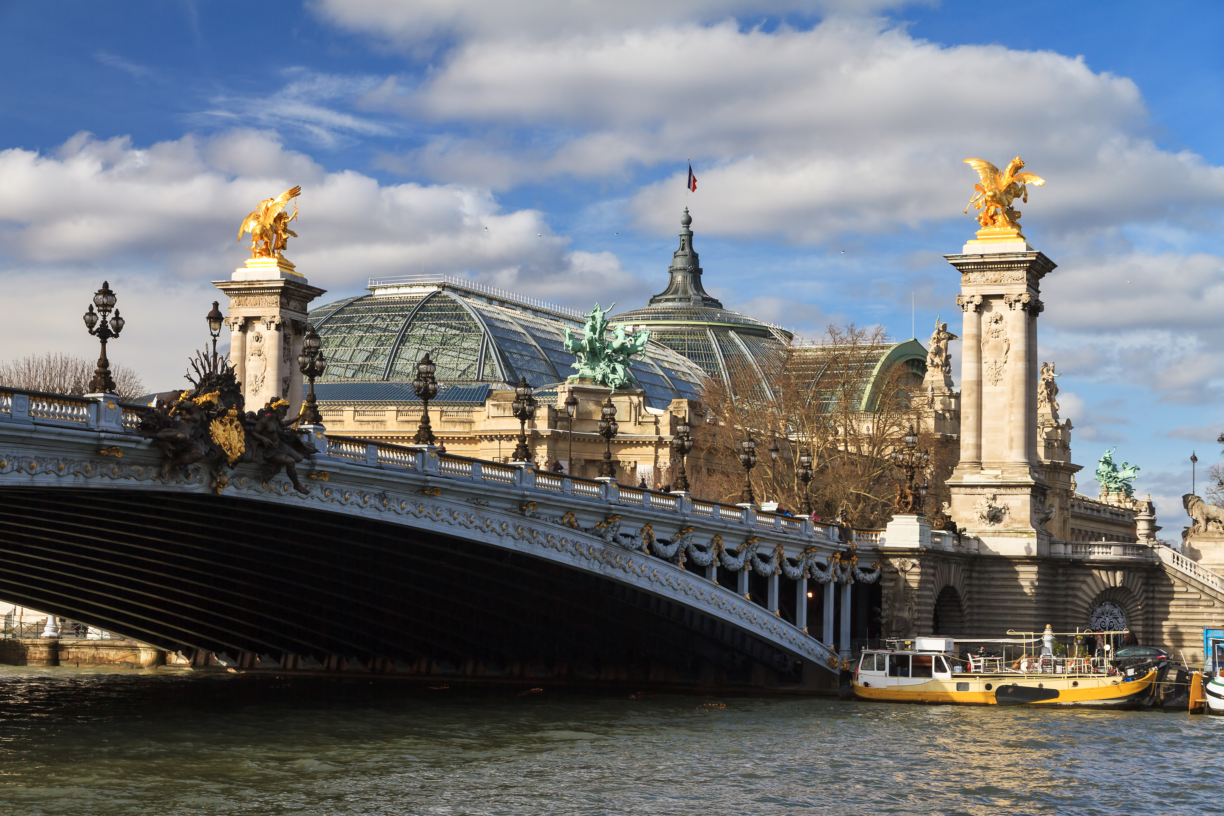 Udsigt fra Seinen over Pont Alexandre III med forgyldte figurer og Grand Palais glasdome, Paris, Frankrig