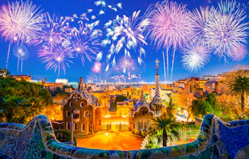 Magisk fyrværkerishow over Park Güell i Barcelona med Gaudís UNESCO-beskyttede parkarkitektur belyst i nattemørket