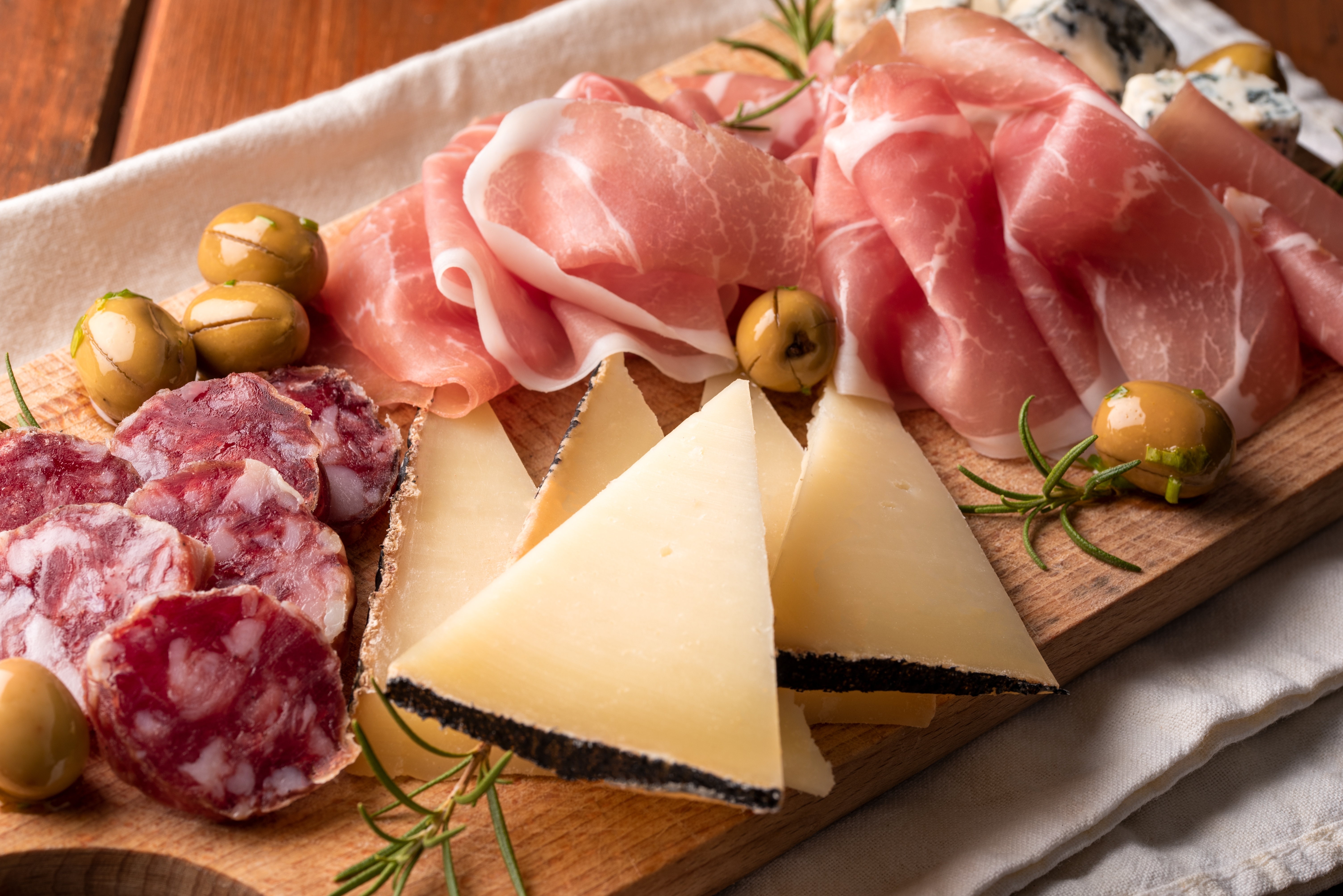 Toscansk antipasti arrangement med prosciutto, italiensk hård ost og oliven