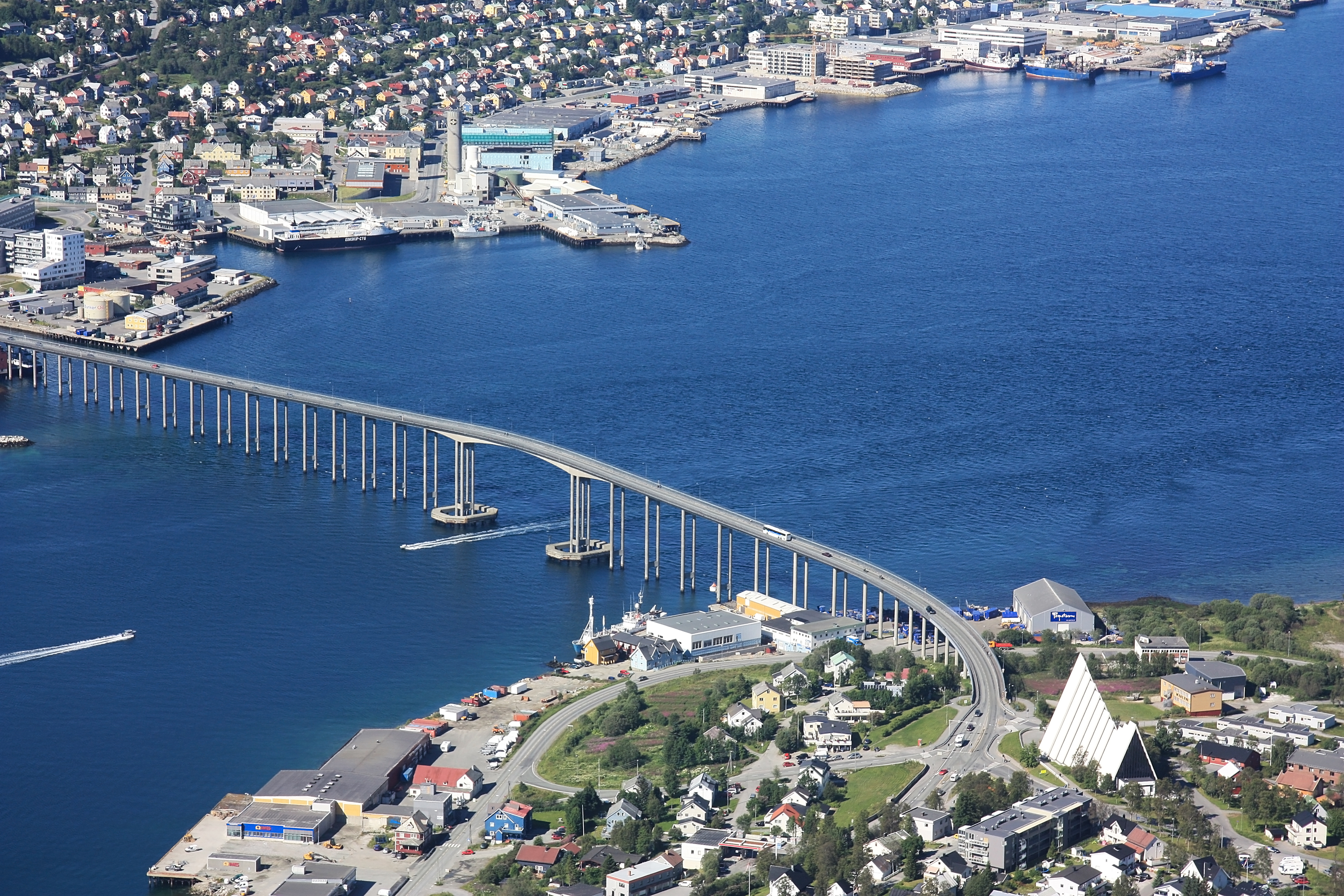 Luftfoto af Tromsø med den lange bro over fjorden og Ishavskatedralen i Nordnorge om sommeren