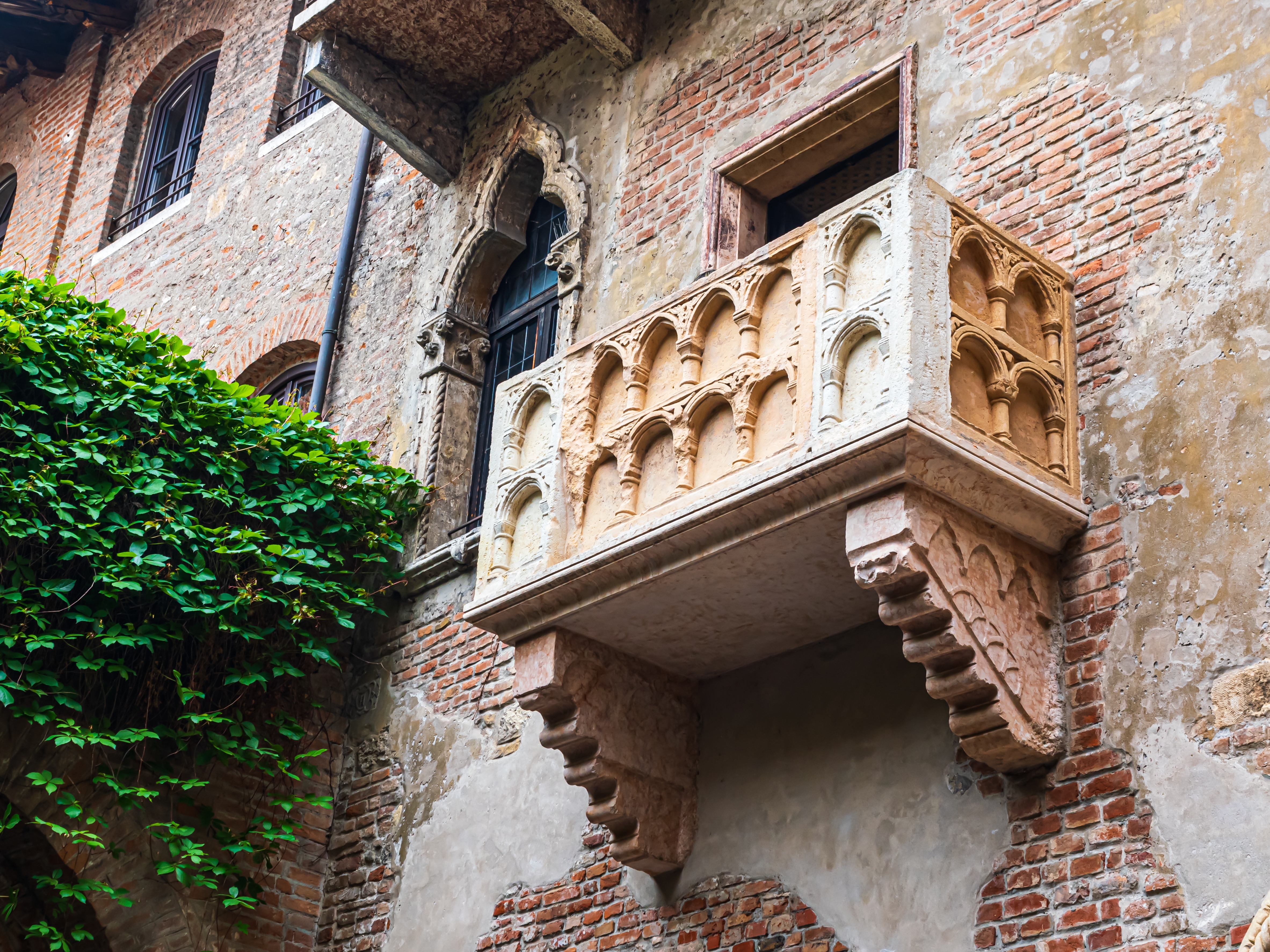 Historisk balkon på Casa di Giulietta i Verona, der symboliserer den udødelige kærlighedshistorie mellem Romeo og Julie, med sin karakteristiske middelalderlige stenfacade i hjertet af Norditalien